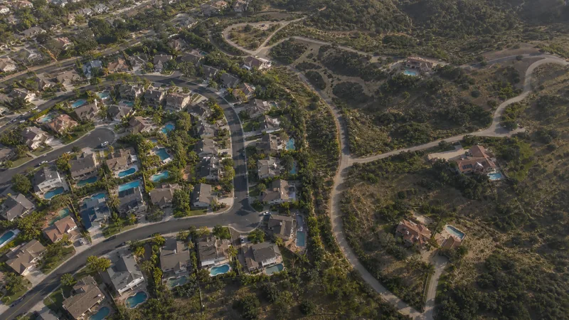 Aerial view contrasting a dense cluster of pools with scattered distant pools