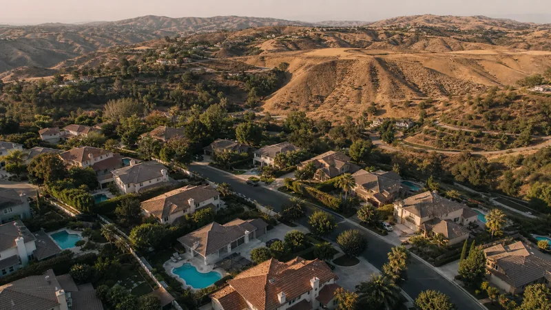 Aerial view of Southern California hillside homes with backyard pools